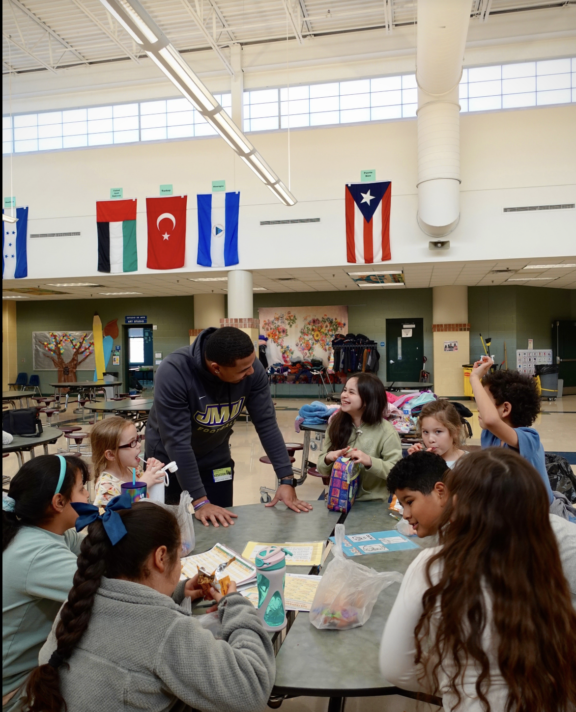 Julio Ayamel working with elementary school students in a classroom setting